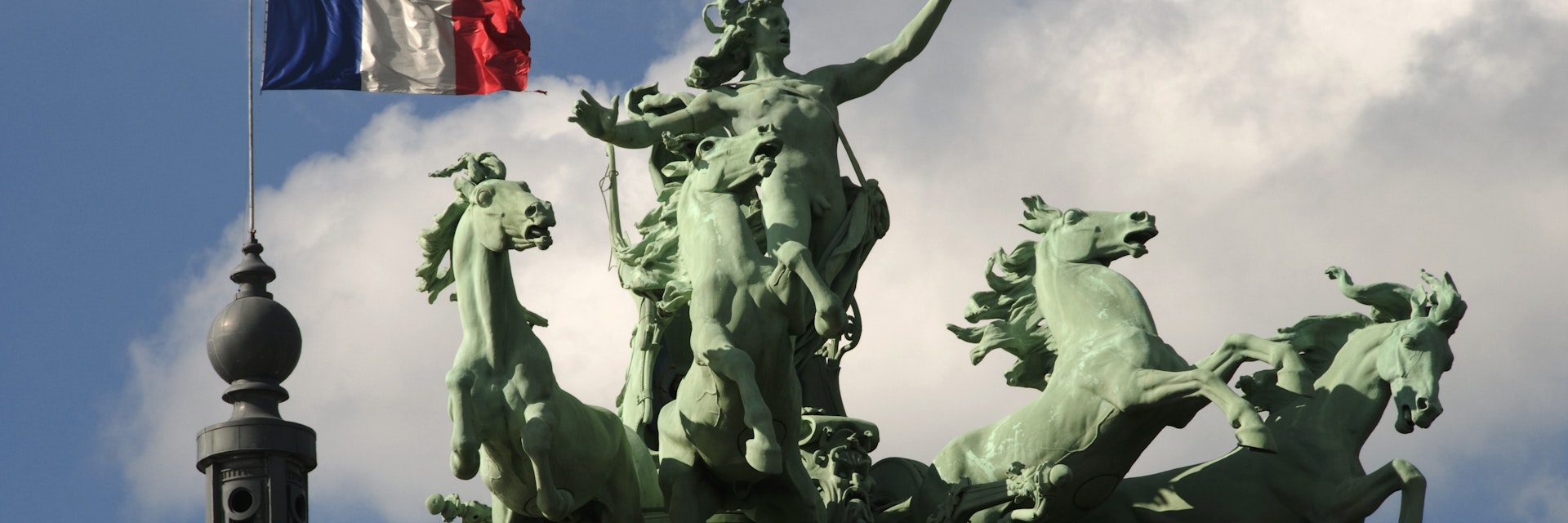 Spire and sculptures on roof of Grand Palais.