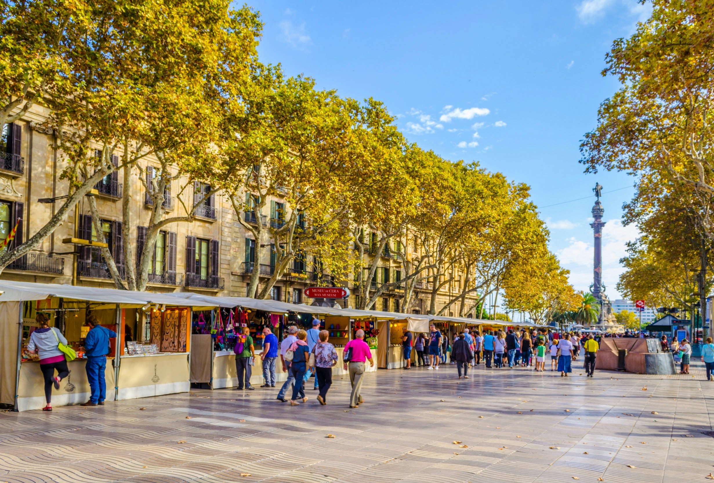 OCTOBER 26, 2014: People walking past market stalls on the La Rambla street in Barcelona.