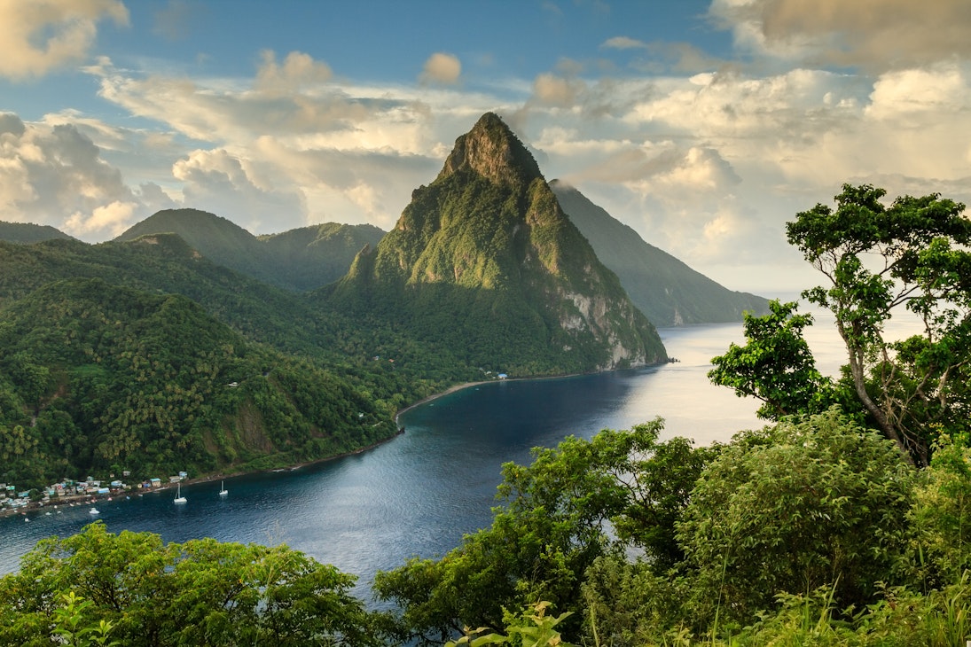 View of the Pitons (Petit Piton & Gros Piton) from an elevated viewpoint with the rainforest and bay of Soufrière in the foreground.