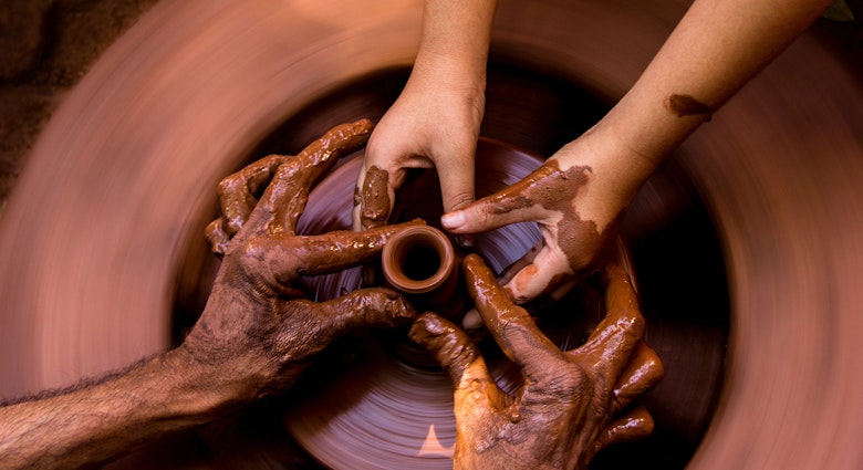Hands of a potter and student