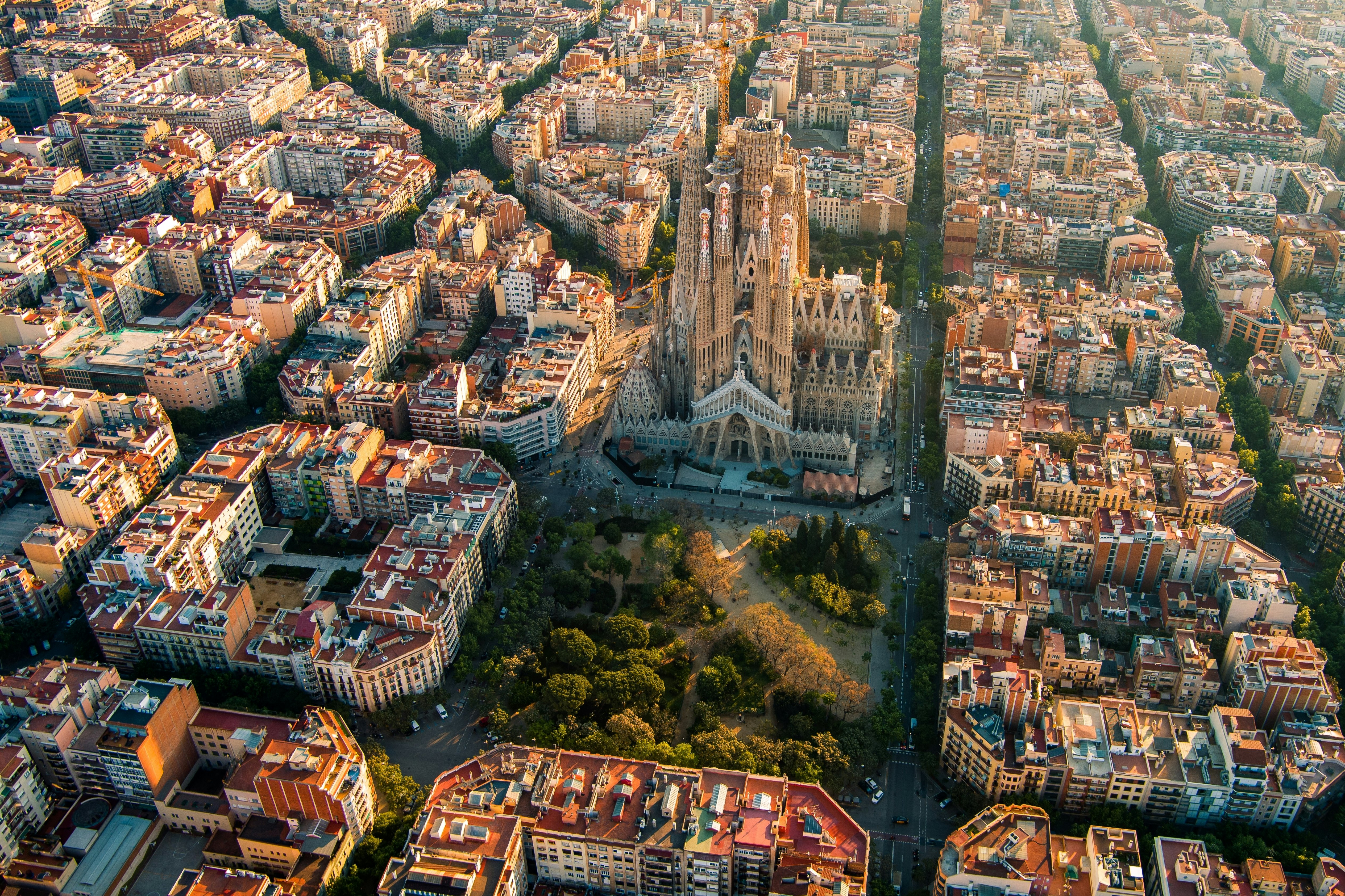Aerial view of Barcelona Eixample district and La Sagrada Família at sunrise.