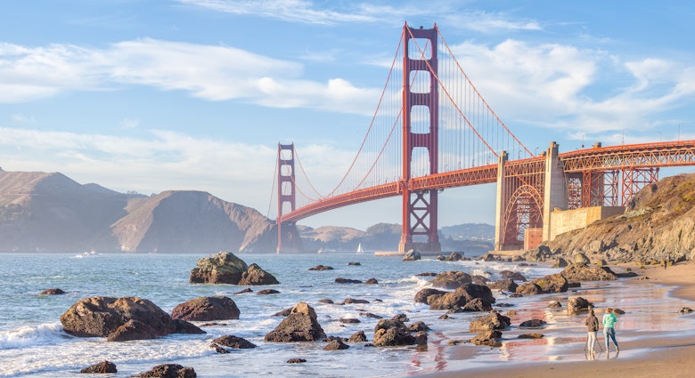 Classic panoramic view of famous Golden Gate Bridge seen from scenic Baker Beach in beautiful golden evening light on a sunny day with blue sky and clouds in summer, San Francisco, California, USA License Type: media Download Time: 2021-08-23T02:27:27.000Z User: mvm_lonelyplanet Is Editorial: No purchase_order: