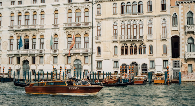 Venice, Italy - 7 October 2022: Water taxi cruising past Palazzo Ferro Fini, a luxury Hotel, License Type: media, Download Time: 2025-04-04T19:34:06.000Z, User: rhylton_redventures, Editorial: true, purchase_order: 65050 - Digital Destinations and Articles, job: Lonely Planet , client: app wip, other: Rhianydd Hylton